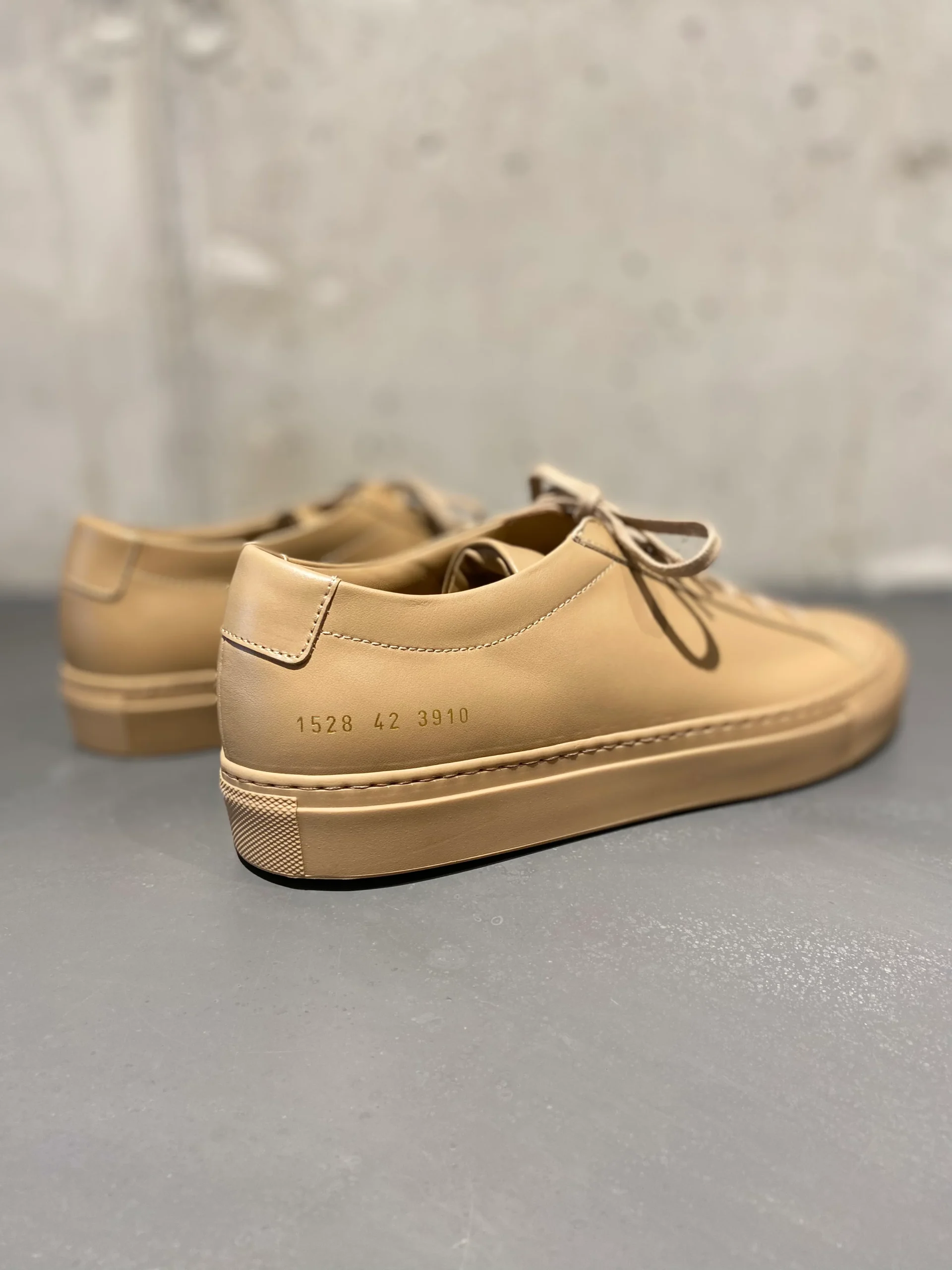 Common Projects Achilles Low close-up of gold-stamped serial number on heel